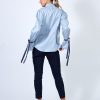 Hanna’s signature pleated-sleeve shirt with velvet ribbon detail in blue